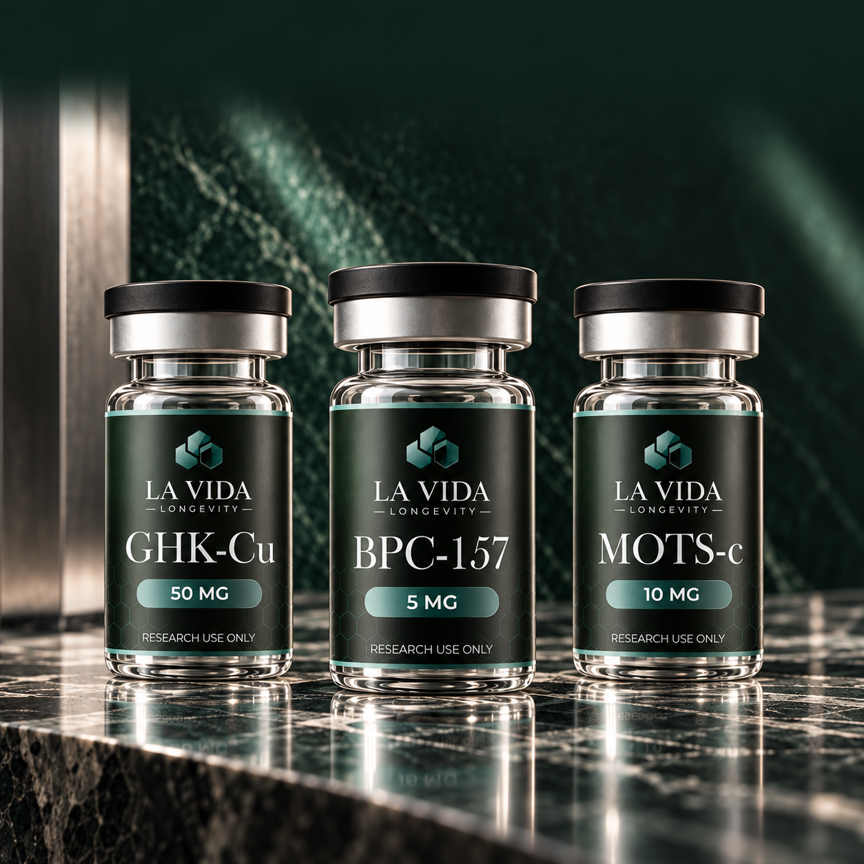 La Vida GHK-Cu, BPC-157 and MOTS-c research vials on green marble